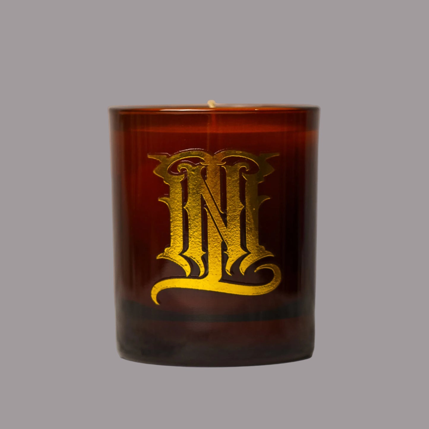 Brown candle with gold lettering 