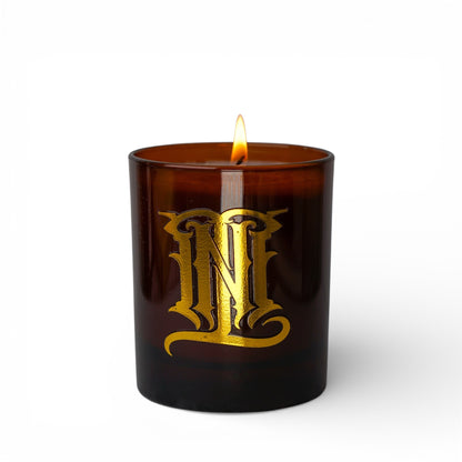 Brown candle with gold logo on a white background