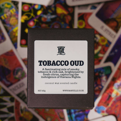 Candle packaging with 'Tobacco Oud' description on a colorful card background