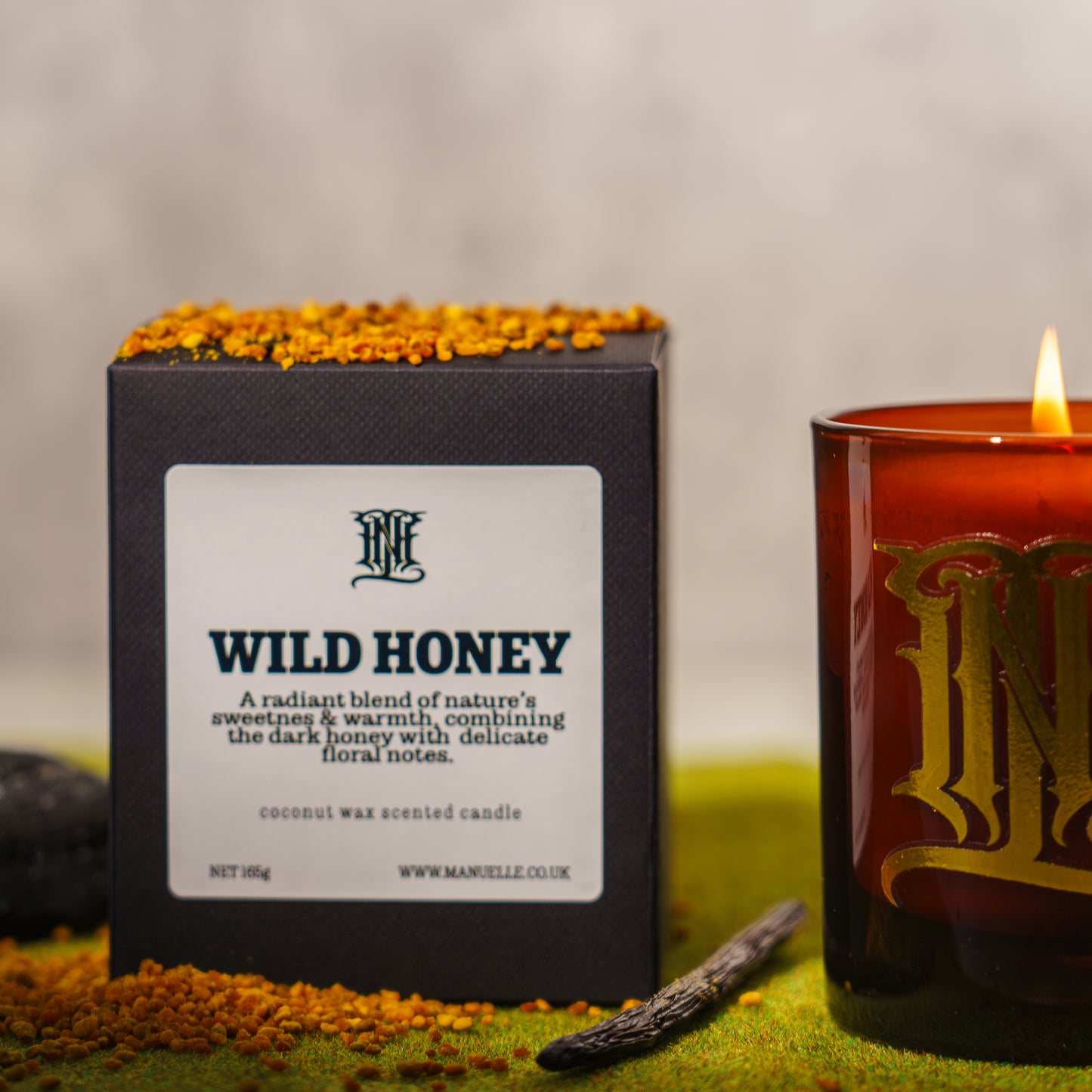 Manuelle Wild Honey candle with packaging on a grassy background